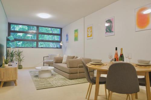 a living room with a table and a couch at 1BR Waterfront Apartment in Barangaroo with Free Private Parking in Sydney