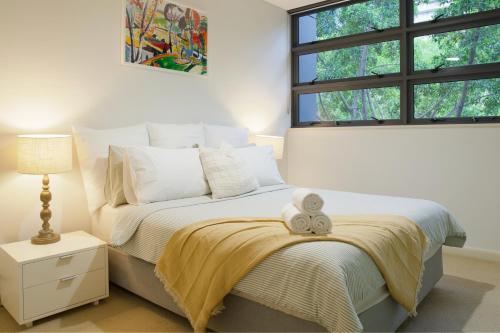 a bedroom with a bed with a teddy bear on it at 1BR Waterfront Apartment in Barangaroo with Free Private Parking in Sydney