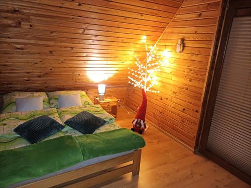 a bedroom with a bed with a christmas tree in it at Domki Bursztyn in Święta Katarzyna