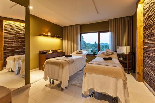 a treatment room with two beds and a window at Hotel Partizán in Tale