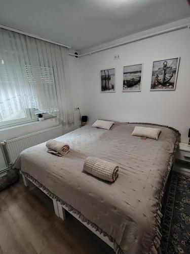 a bedroom with a large bed with two pillows on it at Apartman Novska Noemi in Novska