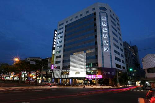 a tall building on a city street at night at Chiayi Look Hotel in Chiayi City