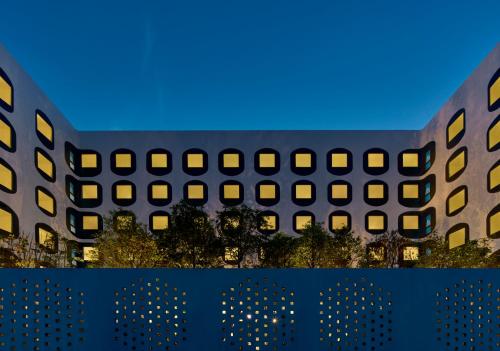an architectural rendering of a building with windows at GO Hotel Bangkok Suvarnabhumi Airport in Lat Krabang
