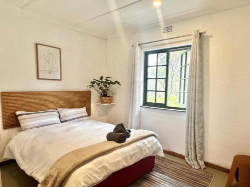 a bedroom with a bed with a stuffed animal sitting on it at Kliprivier Park Tulbagh in Tulbagh