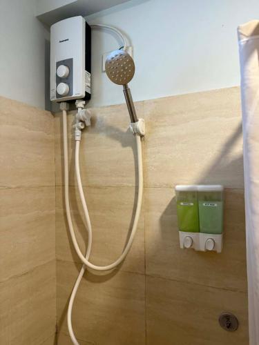 a shower in a room with a hair dryer at Penthouse A Near IT Park in Cebu City