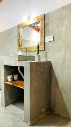 un baño con lavabo y espejo en Inara Stay, en Arugam Bay