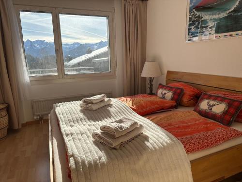 a bedroom with a bed with towels on it at Alpenblick Loft neben Skilift in Amden Arvenbüel in Amden