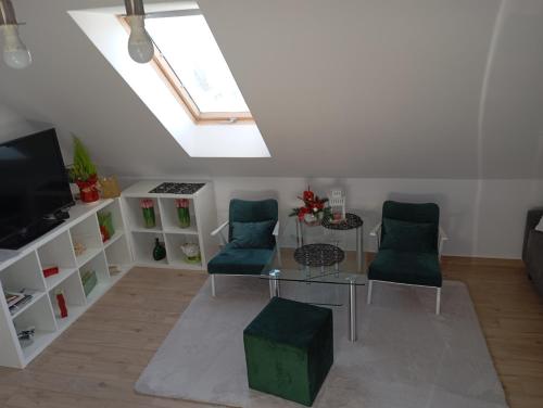 a living room with a skylight and a table and chairs at Apartment/mieszkanie u Janusza in Grybów