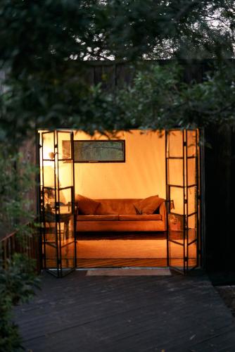 a couch sitting inside of a gate in a backyard at Serene Cabin in a Private Forest in Sedgefield