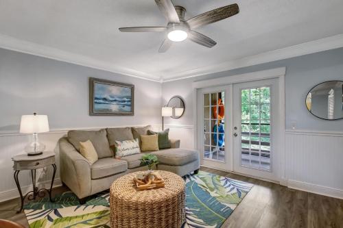 a living room with a couch and a ceiling fan at Fernandina Beach Hidden Gem - Amelia Landings - 9F in Fernandina Beach
