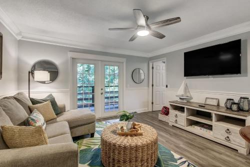 a living room with a couch and a flat screen tv at Fernandina Beach Hidden Gem - Amelia Landings - 9F in Fernandina Beach