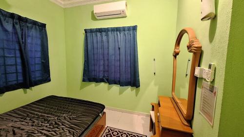 a hospital room with a bed and a window at The Nook Housestay in Ketereh