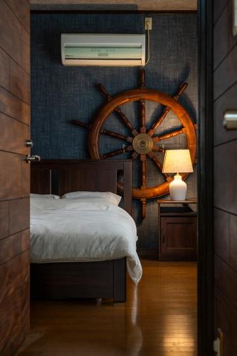 a bedroom with a bed and a wooden wheel at Entire 3 Story house in Hakata in Fukuoka