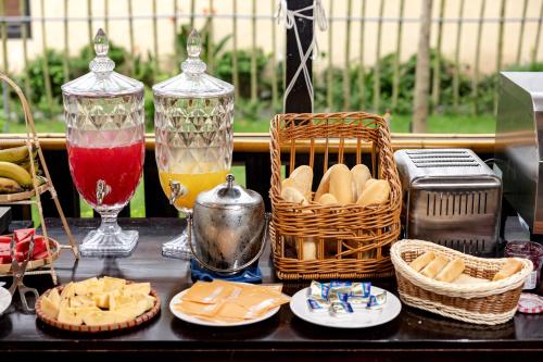 a table with baskets of bread and baskets of food at Scenic Mountain Ecolodge Ninh Binh in Ninh Binh