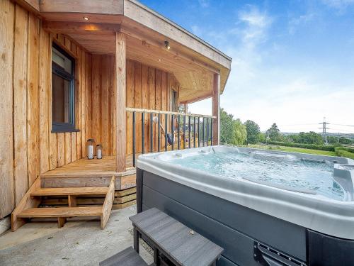 a large hot tub on the deck of a house at The Nest - Uk50122 in Bodelwyddan