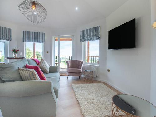 a living room with a couch and a tv at The Nest - Uk50122 in Bodelwyddan