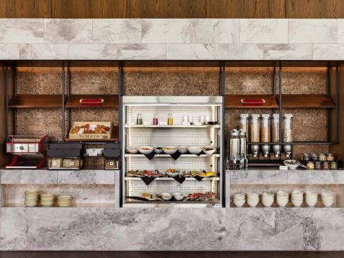 an open refrigerator with food inside of it at Novotel Christchurch Airport in Christchurch