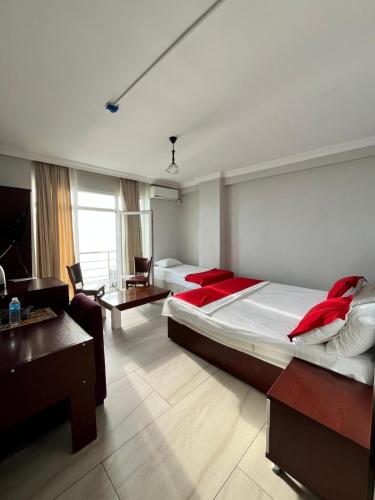 a hotel room with two beds and a couch at Deniz Hotel Kumburgaz in Büyükçekmece