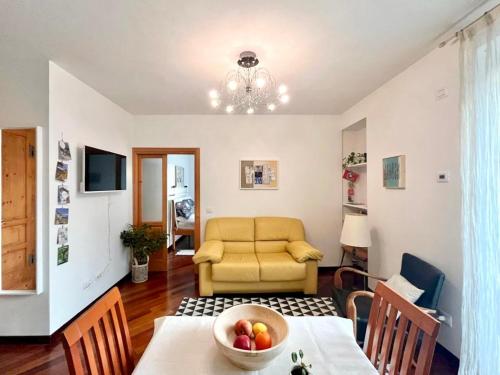 a living room with a table and a couch at casaLaRadice in Tirano