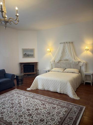 a bedroom with a white bed with a canopy at Minerva in Viareggio