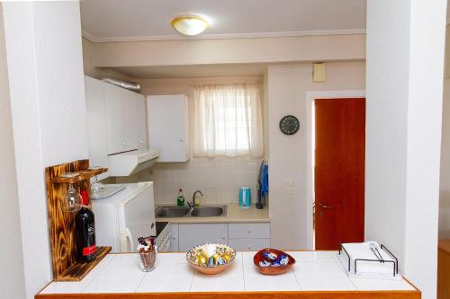 a small kitchen with a counter and a sink at Amadolia in Loutra Edipsou