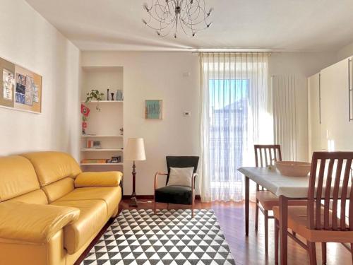 a living room with a couch and a dining room at casaLaRadice in Tirano