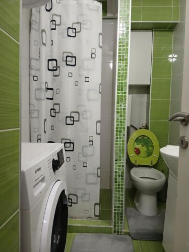 a bathroom with a washing machine and a toilet at Novi Priboj in Čitluk