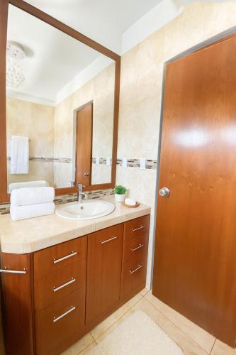 a bathroom with a sink and a mirror at Casa Deluxe Hotel Talara in Talara