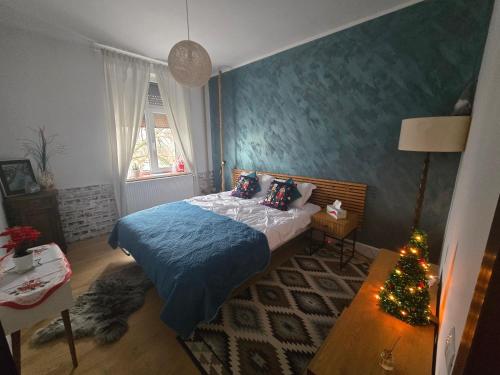 a bedroom with a bed and a christmas tree in it at Mery in Craiova