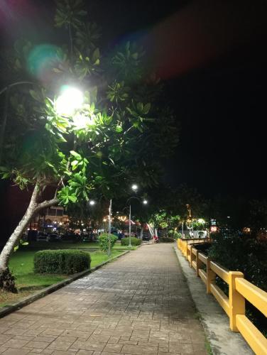 a park at night with a street light and trees at Italay in Krabi