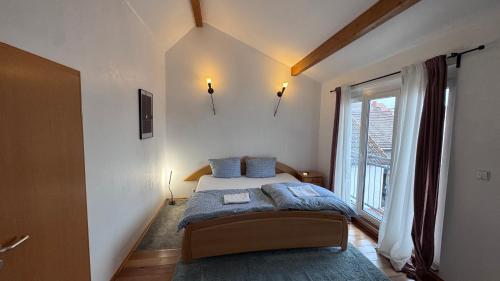 a bedroom with a bed and a large window at Ferienhaus in Lambsheim- "Familienfreundlich", PlayStation-FIFA in Lambsheim