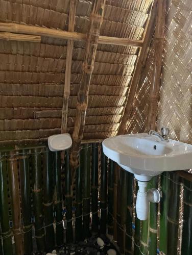 a bathroom with a sink in a room at Diapila baybayon Sunset View in El Nido