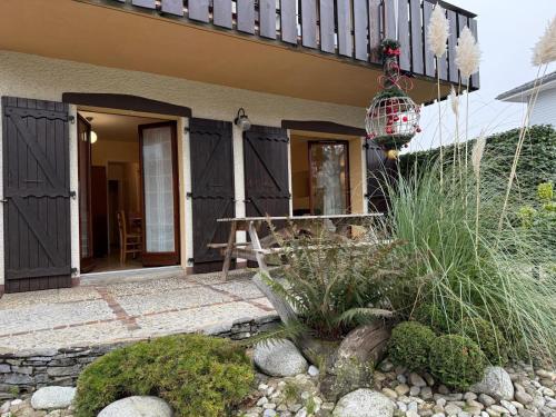 a house with a porch and a balcony with a plant at La ferme de Marin in Marin