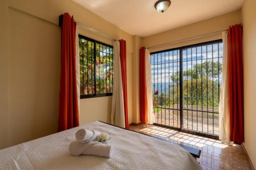 ein Schlafzimmer mit einem Bett und einem Handtuch darauf in der Unterkunft Villa Familiar 3BR Vistas al Valle & Naturaleza in Turrialba