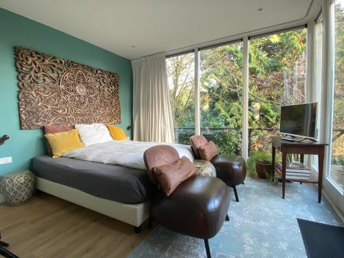 a bedroom with a bed and a large window at Apartment Osso 1, Arnhem in Arnhem