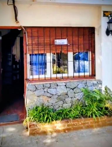 un edificio con finestra e muro di pietra di Duplex Gesell a Villa Gesell