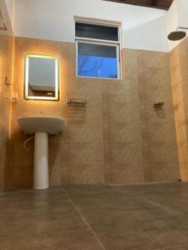 タンガラにあるMargosa villaの洗面台と窓のあるバスルーム