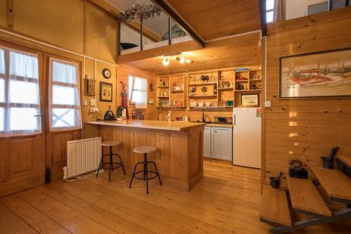 a kitchen with wooden walls and a counter and a refrigerator at Morning Star River Retreat in Belgrade