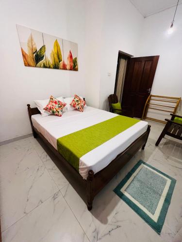 a bedroom with a large bed in a room at Serenique Greens in Kandy