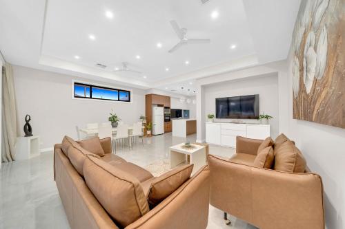 a living room with two couches and a dining room at Luxury on Leeds #2 in Northfield