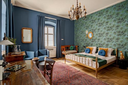 a bedroom with a bed and a blue wall at Giselle Buda Castle in Budapest