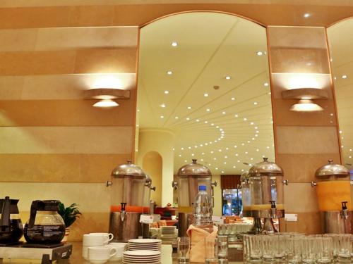 a kitchen with a large mirror in a restaurant at Lancaster Tamar Hotel- Hadath in Beirut