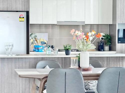 a kitchen with a table and chairs with flowers on it at Modern Penthouse 7-min Walk to Station & Westfield in Sydney