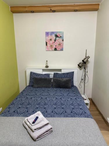a bedroom with a bed with a towel on it at Mājīgs studio apartaments jūras pilsētā in Ventspils