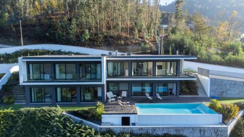 an aerial view of a house with a swimming pool at Gerês Paradise in Geres