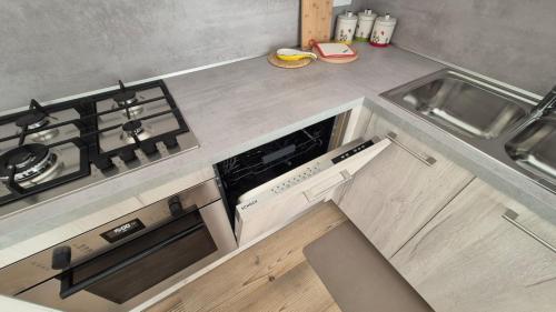 カラルツォにあるCasa Nerinaのコンロ付きのキッチン シンクの横にあるトップオーブン