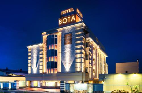 a hotel building with a sign on it at night at HOTEL BOTA 豊橋 -Adult Only- in Toyohashi