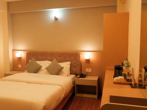 a hotel room with a bed and a mirror at Hotel mustang in Jomsom