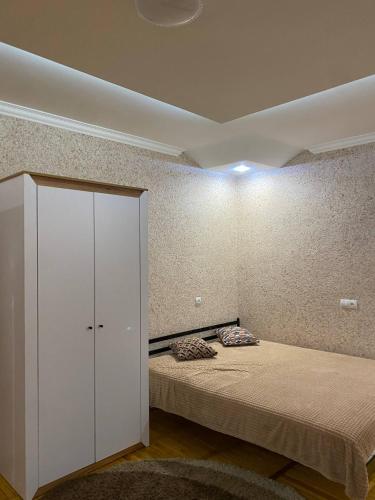 a room with a bed and a cabinet in it at Апарт Отель Элин in Svalyava