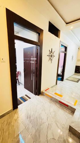 an empty room with a door and a tile floor at devkritii innn stays in Faizābād